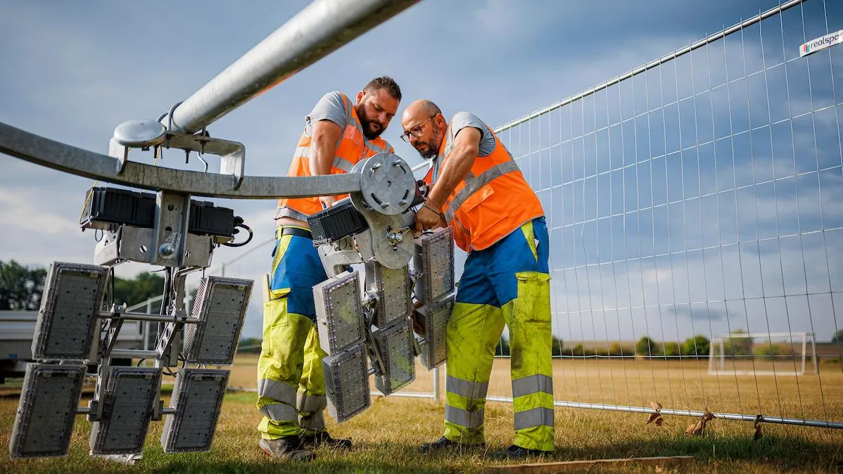 Collègues de terrain préparant l'éclairage de FC Champagne